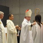 Bishop touching altar servers shoulder