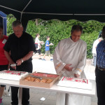 Priests cutting Canada Day cakes